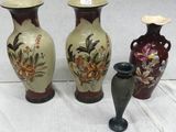 three vases are sitting on a table with a white background