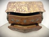 a wooden chest of drawers with a marble top
