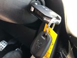 a car key that is attached to the steering wheel of a car