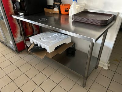 a stainless steel table with a tray on it