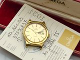 an image of a gold watch in a red box on a white table