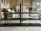 a black shelf with a mirror on it in a living room