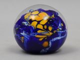 a blue and yellow marble ball on a table