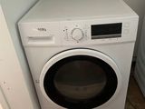 a washer and dryer in the corner of a room