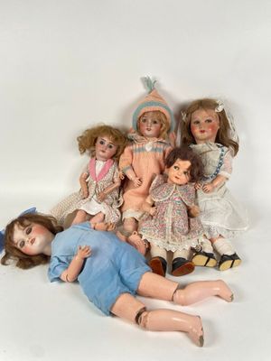 a lot of dolls that are laying on the ground