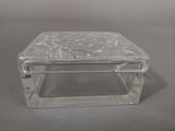 a clear glass box with a flower design on it