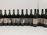 several bottles of wine are lined up in a row on a table