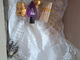 a white dress in a box with a bottle of perfume
