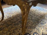 a coffee table with a marble top on a rug