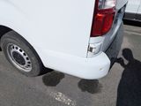 a white van parked in a parking lot next to other cars