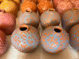 many different colored vases sitting on a table