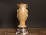 a vase that is sitting on a table with a black background