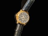 an image of a black and gold watch on a black background