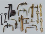 many different types of brass hardware on a white surface