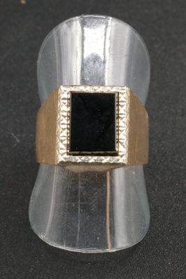 an image of a gold ring with a black stone in it