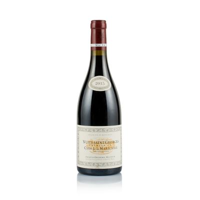 a close up of a bottle of wine on a white surface