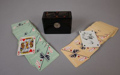 three playing cards and a box on the table