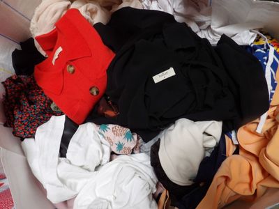 une boîte pleine de vêtements posée sur le sol