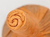 a close up view of a wooden umbrella with a spiral design