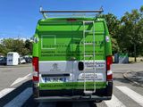 a green van that is parked in a parking lot