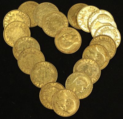 a heart made out of gold coins on a black background