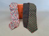 three ties are sitting next to each other on a table