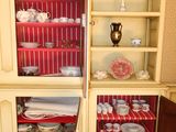 a cabinet that has a lot of plates and bowls in it