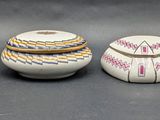 three small white vases are lined up on a black surface
