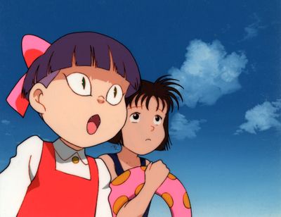 a woman and a child standing together on the beach