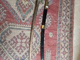 a picture of a knife and a sword on a rug