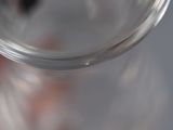 a close up of a glass with a liquid in it