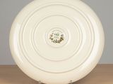 a white plate with a design on it sitting on a table