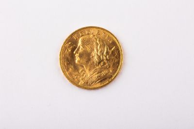 a close up of a gold coin on a white surface