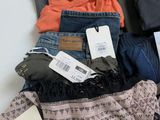 a pile of clothes that is on a table