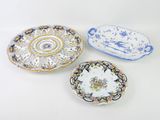 three plates with different designs on them sitting on a white surface