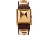 an image of a gold and brown watch on a white background