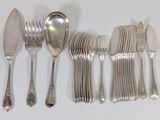 a lot of silver spoons and forks on the table