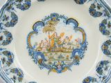 a blue and white plate with a picture of a boat on it