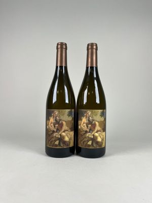 two bottles of wine sitting next to each other on a table