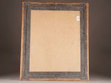 an old picture frame sitting on top of a table next to a wall