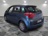 the back of a blue citrole parked on a checkered floor