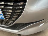 a close up of a car ' s grille with a logo on it