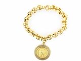 a close up of a gold bracelet with a coin on it