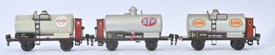 trois wagons de train miniature alignés sur une surface blanche