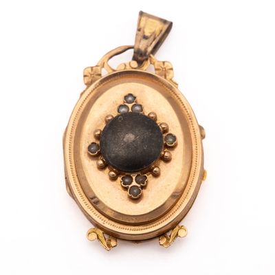 an image of a gold locke with a black stone in the center