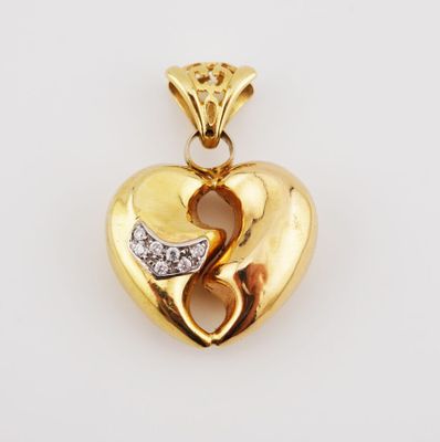 a yellow gold heart pendant with diamonds on a white background