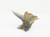 an image of a fish figurine on a white surface
