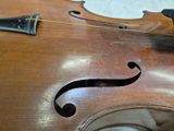 a close up of a violin that is on a table