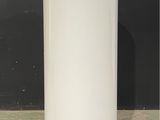an image of a white water tank sitting on top of a cement floor