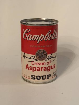 campbell ' s cream of asparagus soup in a can on a white surface